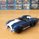 Image for article titled This Cool Fan-Made LEGO Iron Man Garage Has Some Great Models Of The Audi R8 And AC Cobra, Too